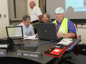 Volunteer Bob Eger (R) works with Robin Friedman of the Red Cross (L) and Kris Nelson of Sacramento OES in the EOC.