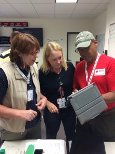 Volunteers Sharon Andrews, Debbie Gentry-Rao, and Gregory Small discuss needs at the fire sites.