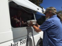 Red Cross volunteers provide SBC-prepared food to affected communities.