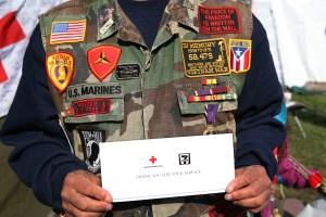 A Vietnam War veteran is thanked for his service with free coffee and donut coupons, provided by 7-Eleven, at the Red Cross tent on the National Mall.